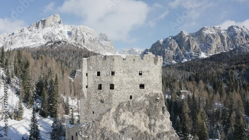 Medieval ruins of castle Andraz with natures Dolomite mountains backdrop AERIAL photo