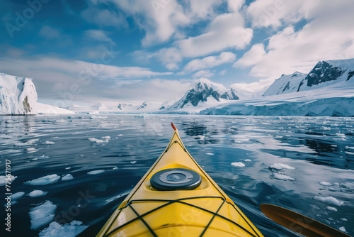 Extreme tourism, winter kayaking in Antarctica, adventurous man paddling on sea kayak between icebergs.