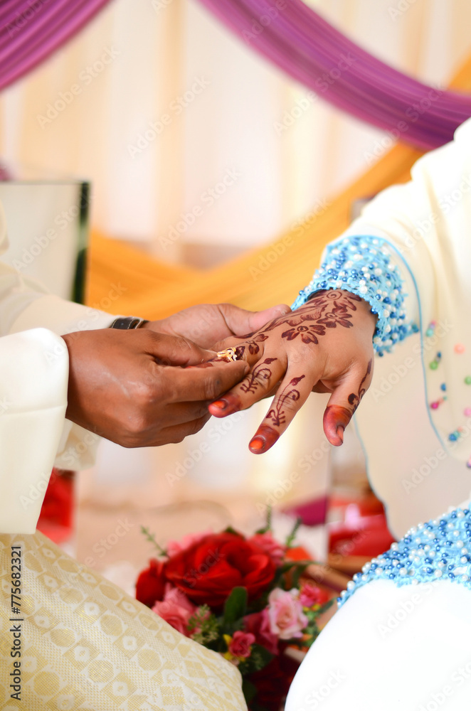 Groom put a ring on finger of his lovely wife. Close up image and selective focus. Groom put a ring on finger of his lovely wife. Close up image and selective focus.