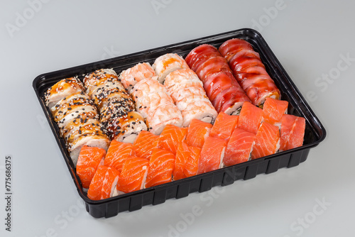 Different sushi in open plastic packaging for take-out food