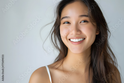 Closeup portrait of Beautiful smiling Asian woman with smooth healthy skin