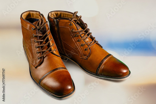 A pair of premium calfskin boots with a multi-colored background. Horizontal shot.