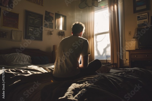 depressed man sadly sitting on the bed in the bedroom