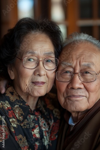 Portrait of senior old smiling Asian couple in love standing wearing casual clothes © Darya Lavinskaya