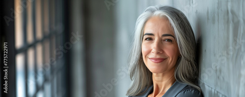 Portrait of a smiling mature woman with gray hair. photo