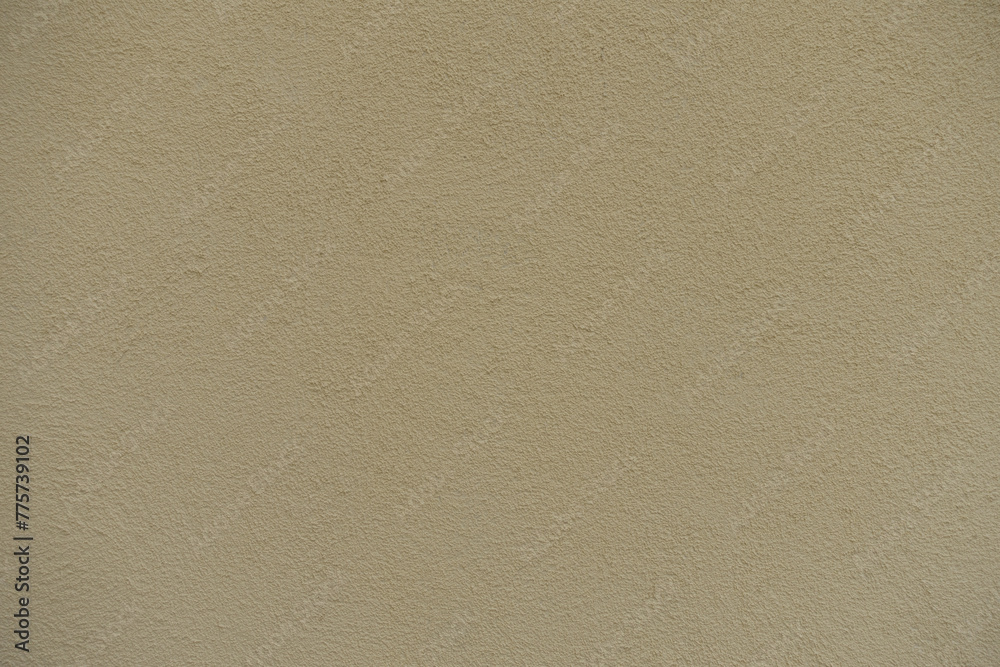 Surface of wall with coarse light beige roughcast finish Surface of wall with coarse light beige roughcast finish