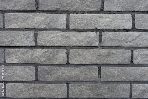 Close view of gray artificially aged brick veneer wall