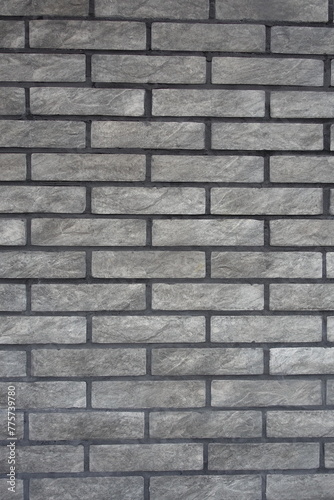 Loft style gray artificially aged brick veneer wall