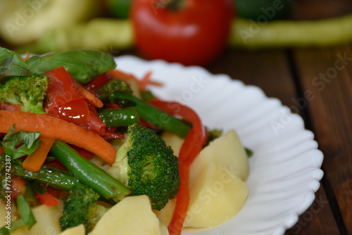 Fresh vegetables on a plate closeup. Healthy diet concept with vegetables, peas, broccoli, peppers, potatoes