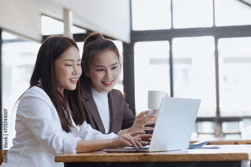 Two asian businesswoman or coworkers working on project in modern office. Two asian businesswoman or coworkers working on project in modern office.