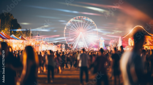 Defocused People crowd enjoying day at amusement park. © PaulShlykov