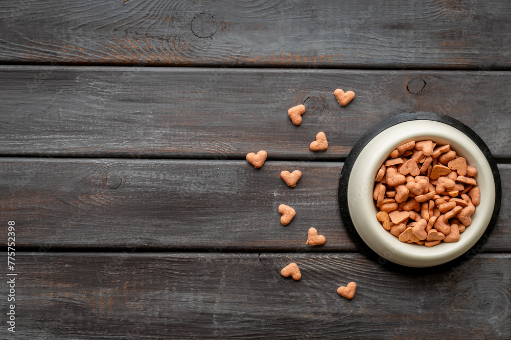Bowl of biscuits for pets - food in a shape of heart, top view Bowl of biscuits for pets - food in a shape of heart, top view