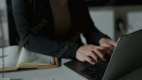 FPV view of professional businesswoman cross her arms confidently after finish typing and working on laptop document and calculator about business accounting financial and marketing photo