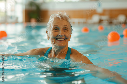 Mature woman wearing at swimming pool. Fit active senior woman enjoying retirement in swimming pool. Happy senior healthy old woman enjoying active lifestyle.