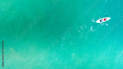 Top view of kayak boat oin shallow turquoise water of Kapas Island sea, Kuala Terengganu, Malaysia.