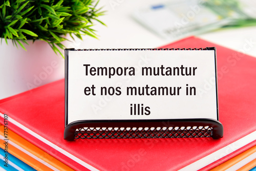 Tempora mutantur et nos mutamur in illis Translated from Latin, it means Times are changing, and we are changing with them. on white business cards in delivery on a light background photo