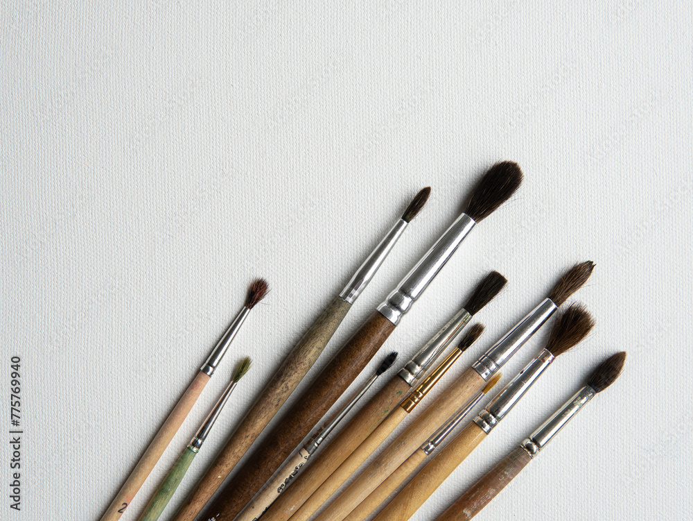 wooden watercolor brushes lie on a white canvas wooden watercolor brushes lie on a white canvas