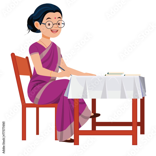 Indian lady Teacher sitting at table in classroom