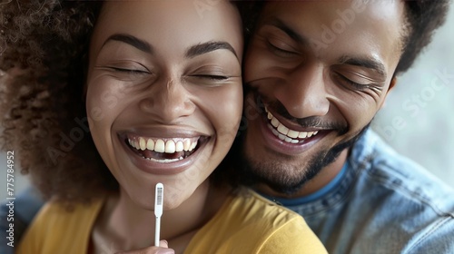 Close-up of a joyful couple and a positive pregnancy test, their smiles reflecting the happiness of their newfound journey into parenthood photo