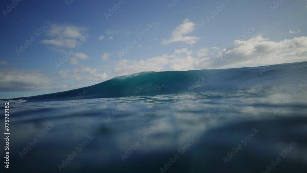 Turquoise blue water at ocean surface as wave breaks into deep barrel Turquoise blue water at ocean surface as wave breaks into deep barrel