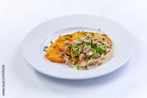 potato pancakes with mushrooms on white plate