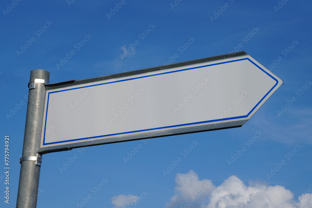 Metal signpost with one arrow and sky in background Metal signpost with one arrow and sky in background