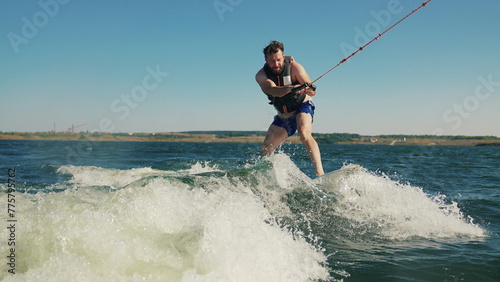 An amateur wakeboarder learns to surf the waves with an akater.