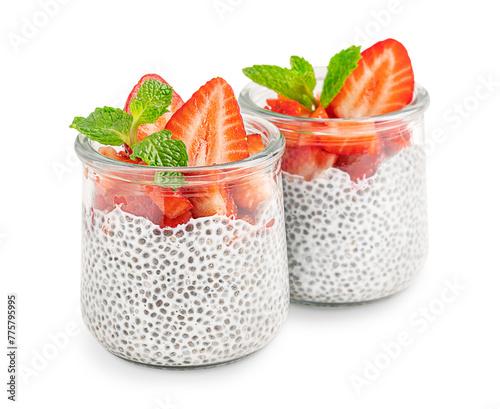Homemade sweet vegetarian chia pudding healthy dessert made with seeds soaked in alternative milk decorated with sliced juicy strawberry topping and fresh mint leaf in glass jar isolated on white
