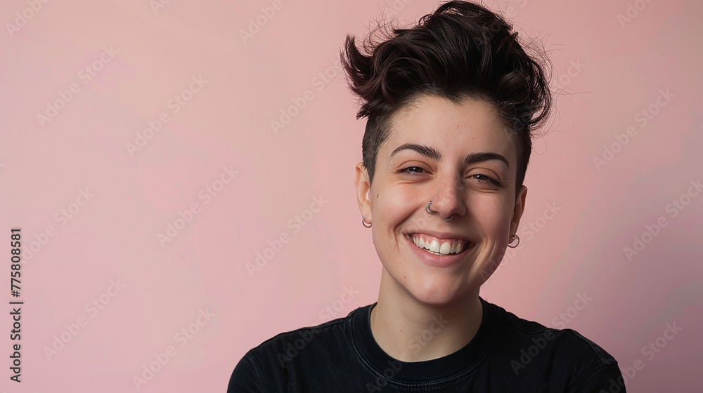 Androgynous woman with a punk style smiling against a solid color background