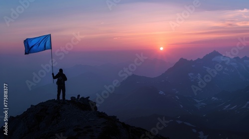Hiker assisting companion reaching mountain top at sunrise