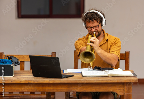 Inspirational one-armed trumpeter composing music at home