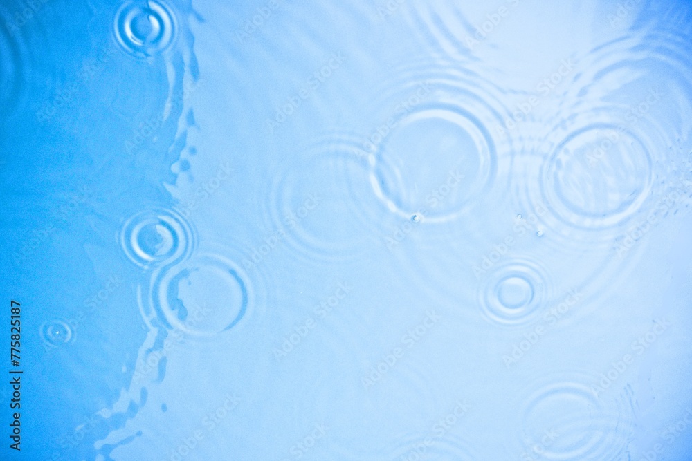 Blue water texture, aqua surface with rings and ripples. Natural summer background for skin care cosmetics advertisement, Top view Blue water texture, aqua surface with rings and ripples. Natural summer background for skin care cosmetics advertisement, Top view