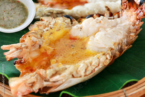 Close-up of grilled giant River Prawn or River Shrimp on the wooden plate with sea foods sauce of Thai style. Foods concept.