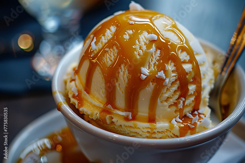 A scoop of creamy caramel ice cream drizzled with salted caramel sauce.