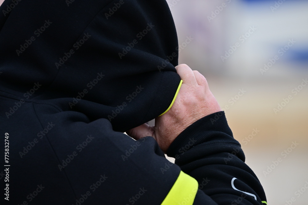 A man tries to protect his face from the heavy, sandy wind at the Bech of Benidorm-Spain. A man tries to protect his face from the heavy, sandy wind at the Bech of Benidorm-Spain.