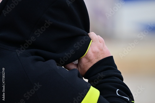 A man tries to protect his face from the heavy, sandy wind at the Bech of Benidorm-Spain.