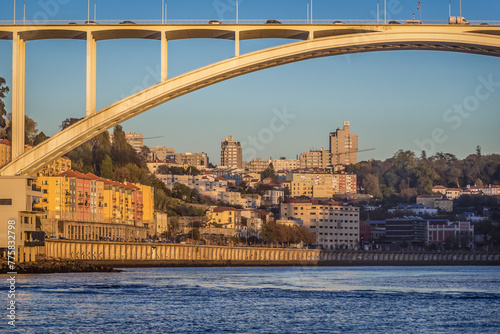 Arrabida Bridge over Douro River and buildings in Porto city, Portugal photo