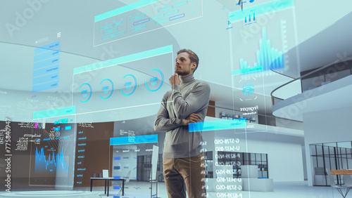 Fototapeta Naklejka Na Ścianę i Meble -  Portrait of Futuristic Businessman Activating Data Analysis in a Virtual Space. Person Gesturing with Augmented Reality Hologram Information, Financial Reports, Stock Market Reports, Infographics