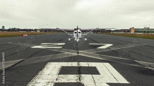 A small private plane is landing at the airport.