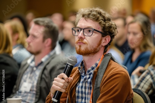 Engaged Audience Member Holding Microphone at Seminar