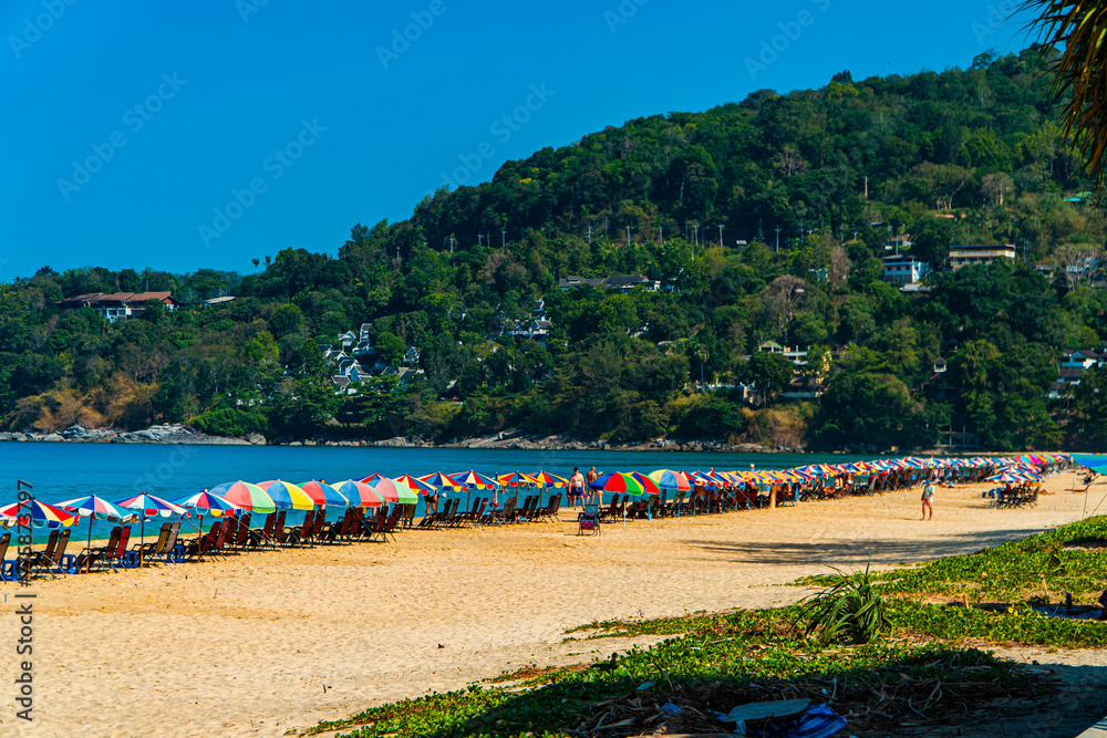 Karon Beach, one of the favorite beaches visited by tourists to play in the water, sunbathe or just enjoy the tropical climate in Phuket, Thailand. The beauty of Karon beach on a hot day Karon Beach, one of the favorite beaches visited by tourists to play in the water, sunbathe or just enjoy the tropical climate in Phuket, Thailand. The beauty of Karon beach on a hot day