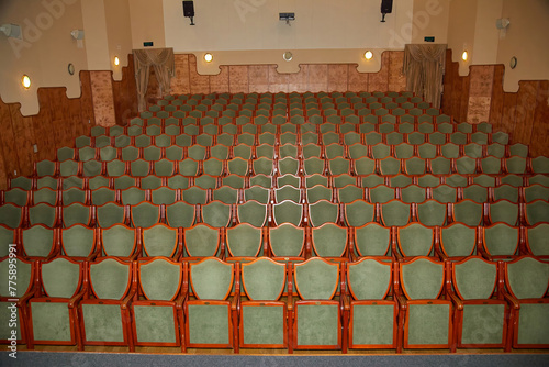  rows of green chairs in a theater auditorium