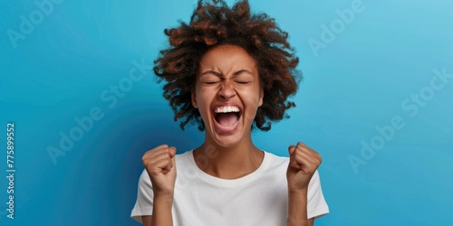 A woman with her mouth open and her hands raised in the air. Suitable for various concepts and themes photo