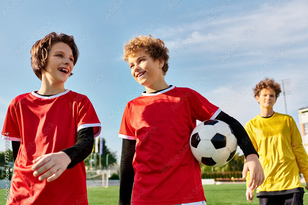 Fototapeta premium A group of young men stand next to each other on a soccer field, showcasing a sense of camaraderie and teamwork as they prepare for the game ahead.