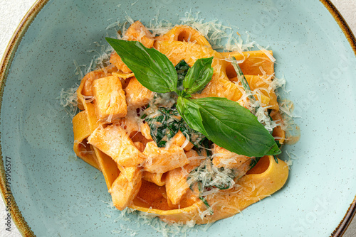 Closeup on portion of fettuccine pasta with salmon and spinach
