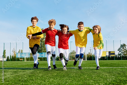 A group of young men engaged in a lively soccer game, kicking the ball around as they compete on the field with energy and teamwork.