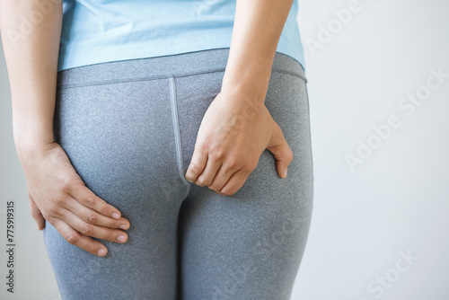 concept of health problems woman has hemorrhoids