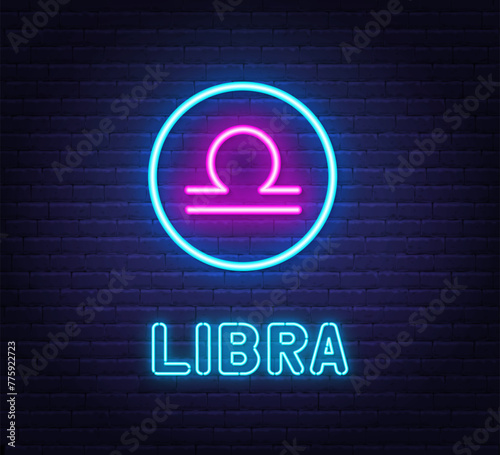 Neon Libra Sign on brick wall background.