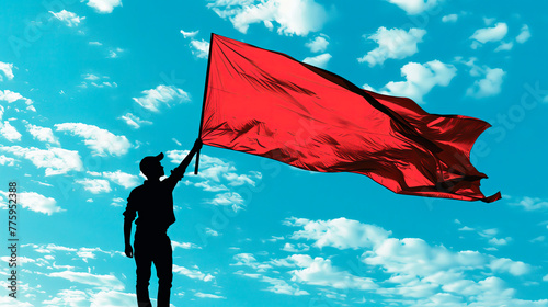 Silhouette with red flag against blue sky  symbol of international workers day.
