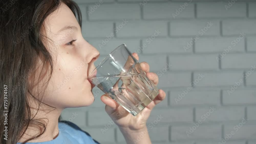 Teen drinking glass of fresh pure water. A view of young girl drinking the still water at home. A concept of eco life and healthy childhood. Teen drinking glass of fresh pure water. A view of young girl drinking the still water at home. A concept of eco life and healthy childhood.